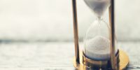 time is ticking - hourglass on the table with copy space
