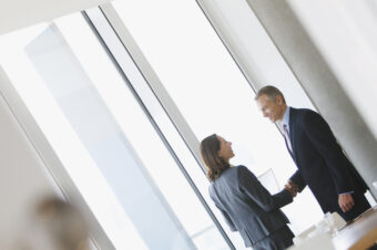 Business people shaking hands in conference room